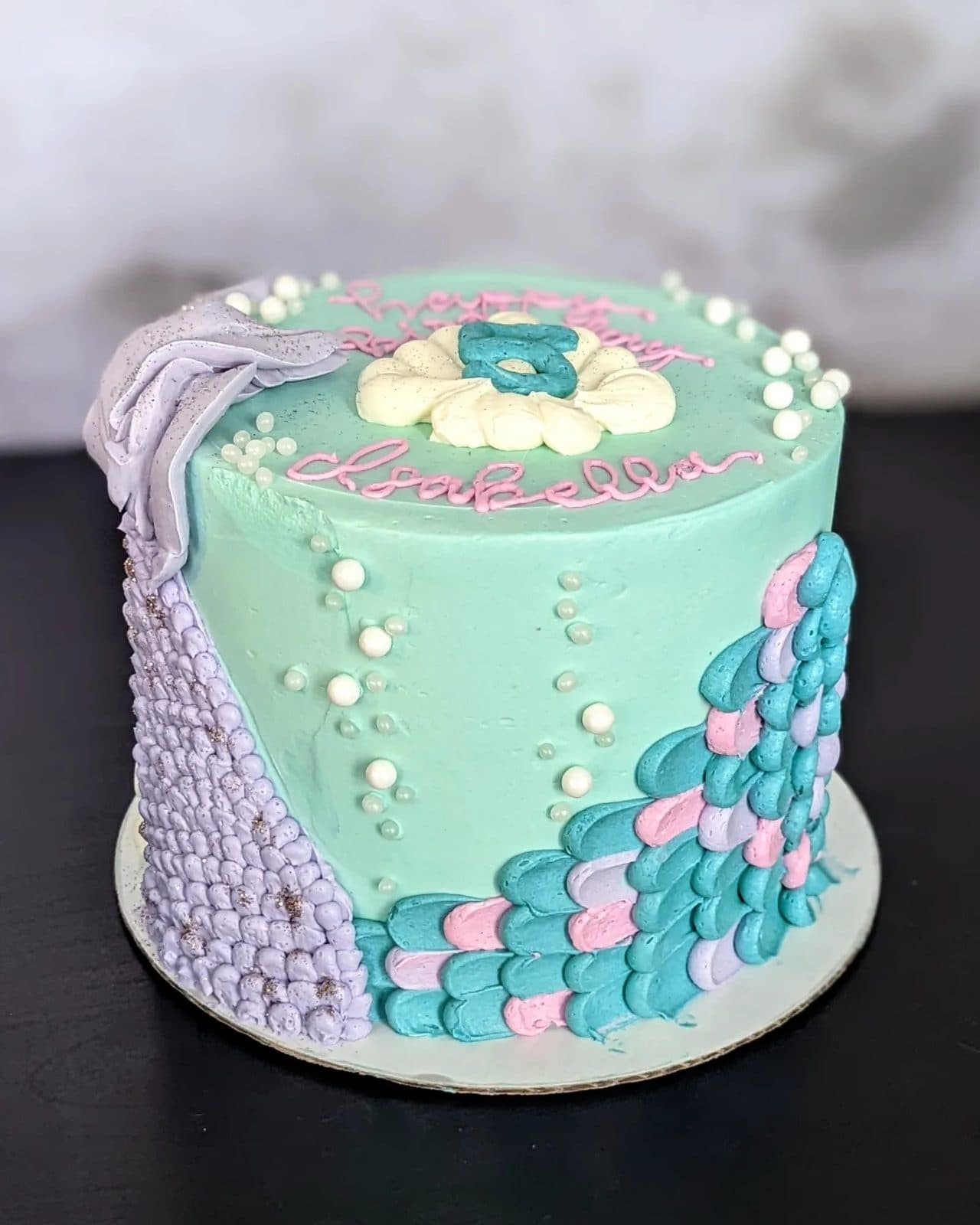 Close view of the scaled pink and purple buttercream tail.