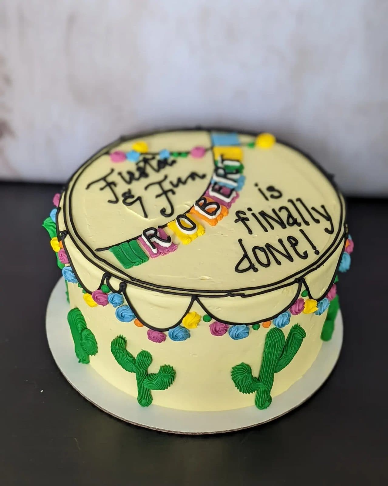 Another view of the pale blue cake topped with buttercream succulents.