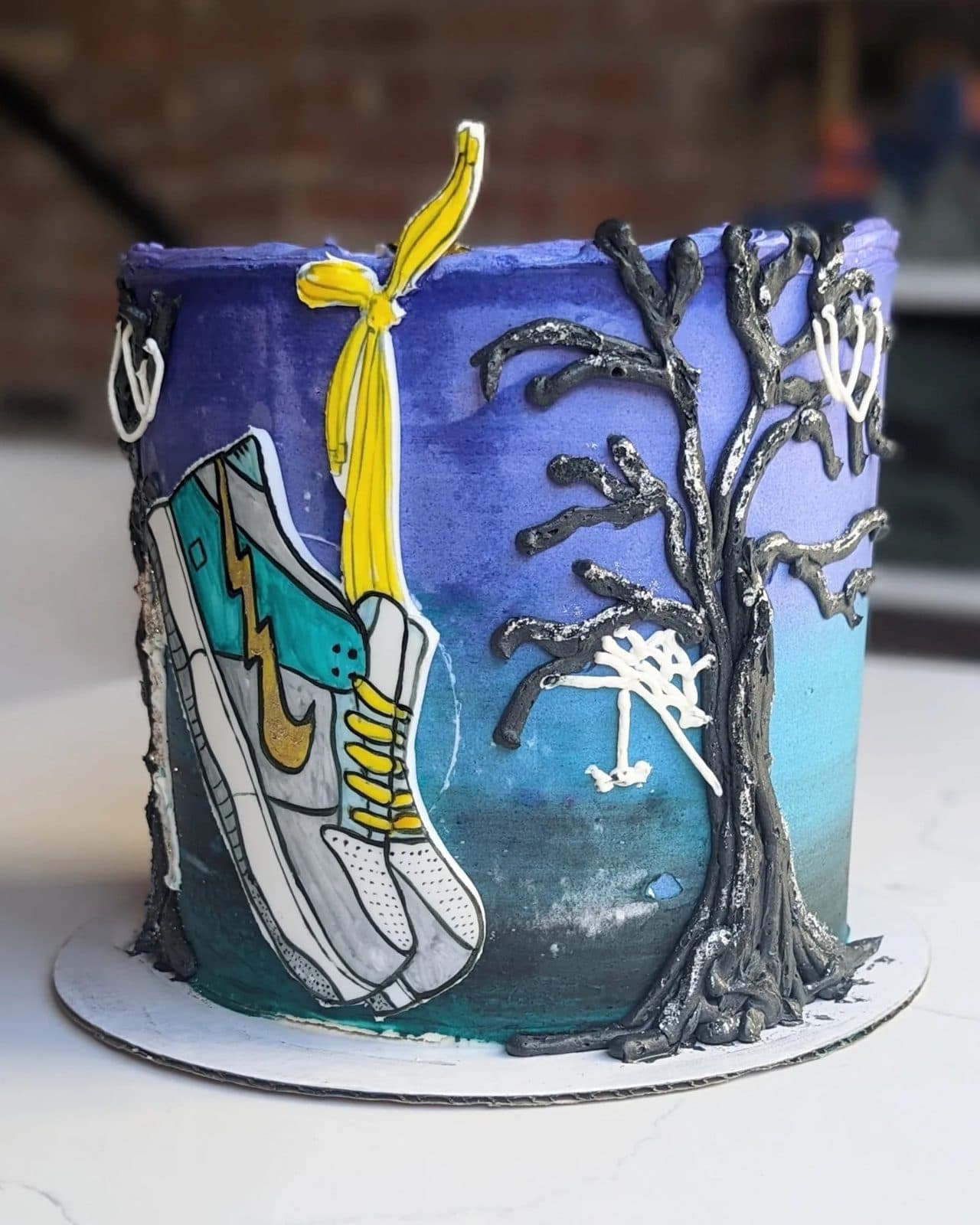 Side view of the Harry Potter cake, candles and stars on the deep blue frosting.