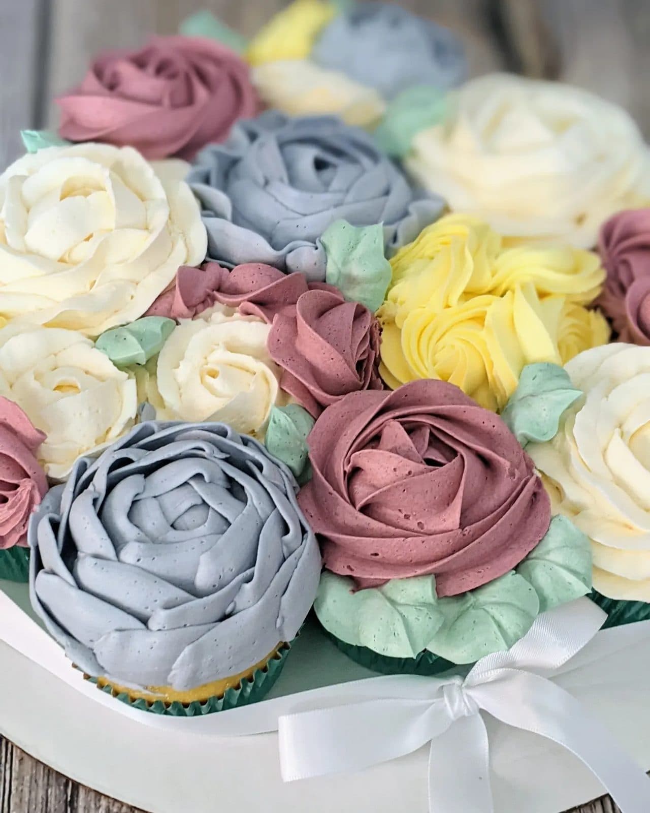 Another view of the buttercream flower cake on its white board.